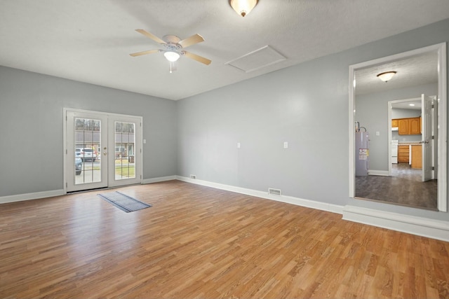 unfurnished room featuring ceiling fan, light hardwood / wood-style floors, and water heater