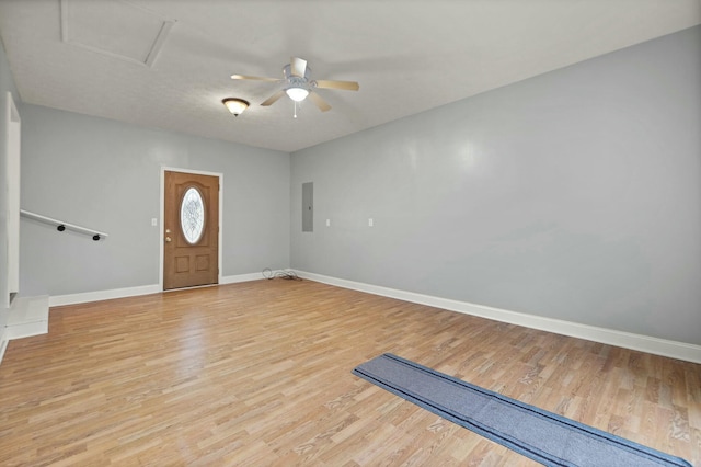 entryway with electric panel, ceiling fan, and light wood-type flooring