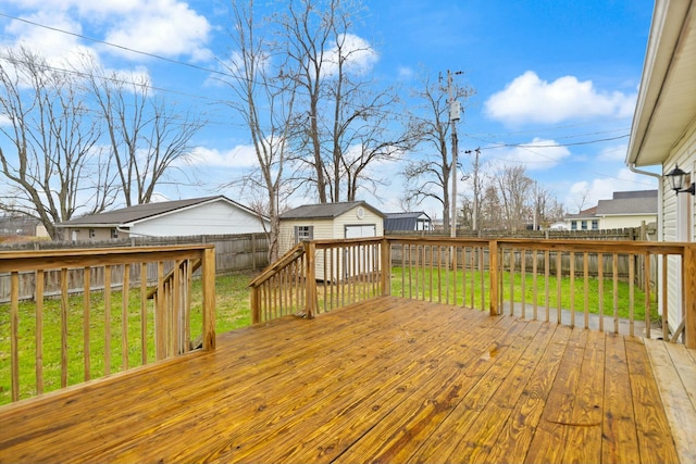 deck featuring a yard and a storage unit