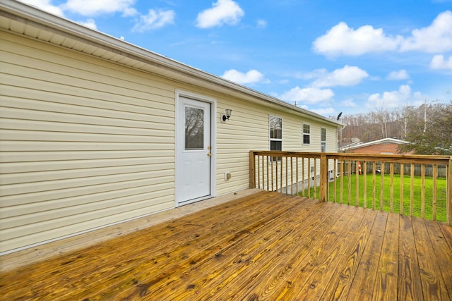 wooden deck with a lawn