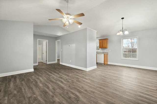 unfurnished living room with ceiling fan with notable chandelier, dark hardwood / wood-style floors, and vaulted ceiling