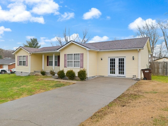 ranch-style house featuring french doors and a front lawn