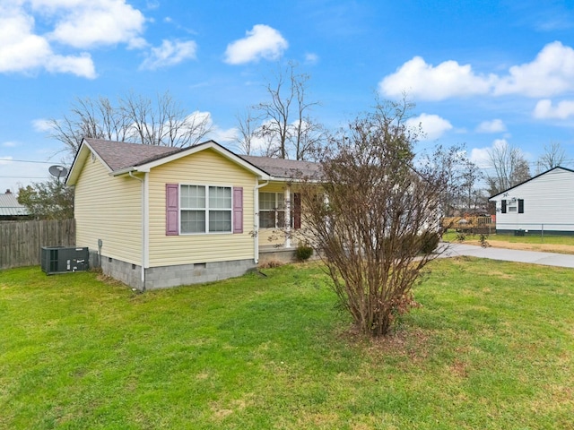 view of front of property featuring cooling unit and a front lawn