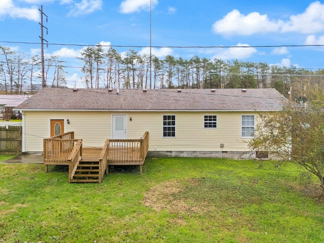 back of house with a deck and a lawn