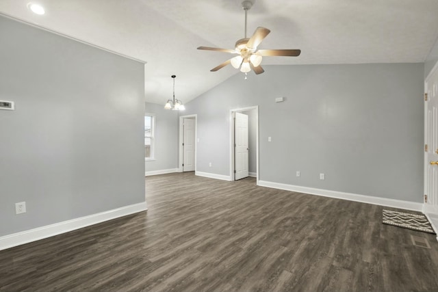 unfurnished room with ceiling fan with notable chandelier, dark wood-type flooring, and lofted ceiling