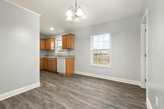 kitchen with decorative light fixtures, white dishwasher, a notable chandelier, and a healthy amount of sunlight