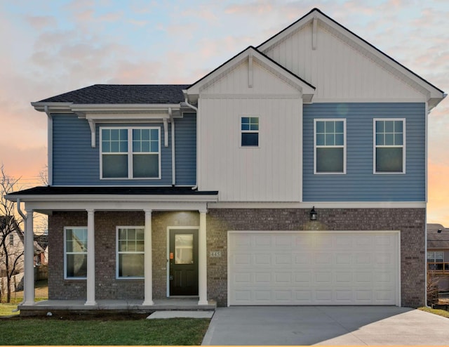 view of front facade featuring a porch, brick siding, driveway, and an attached garage