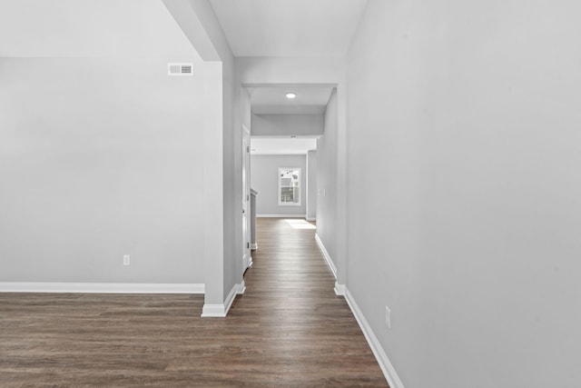 hall with baseboards, visible vents, dark wood finished floors, and recessed lighting