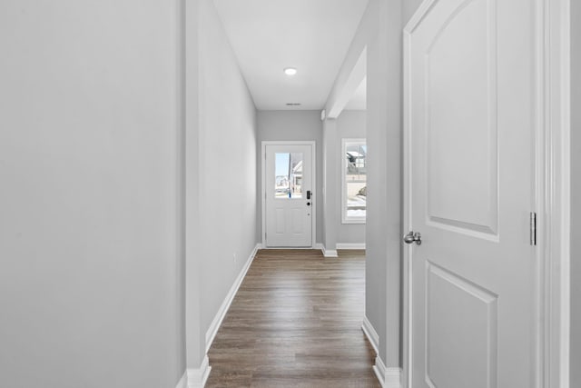 entryway with baseboards and dark wood-type flooring