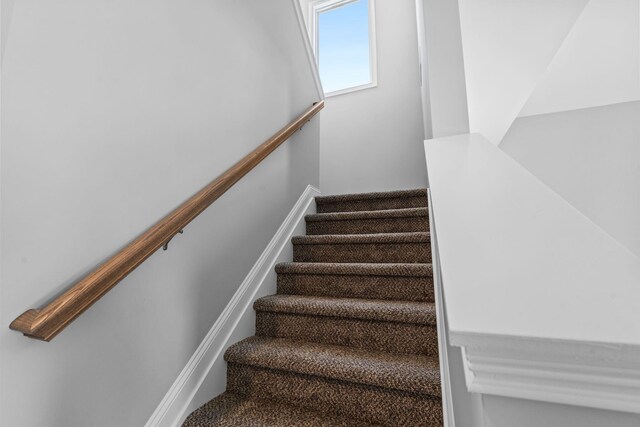 carpeted spare room with baseboards and visible vents