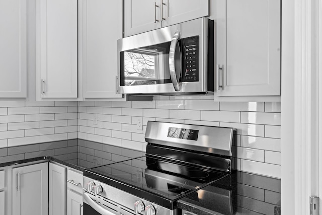 kitchen featuring white cabinetry, appliances with stainless steel finishes, and decorative backsplash