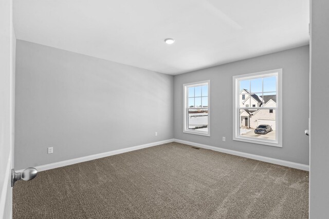 unfurnished bedroom featuring carpet, a closet, visible vents, and baseboards