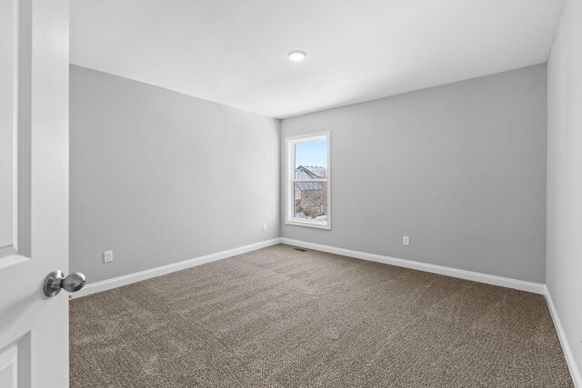 unfurnished bedroom featuring carpet, a closet, visible vents, and baseboards