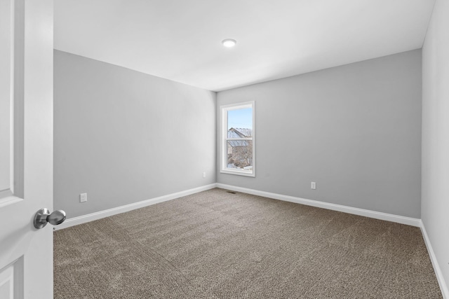 carpeted spare room with baseboards