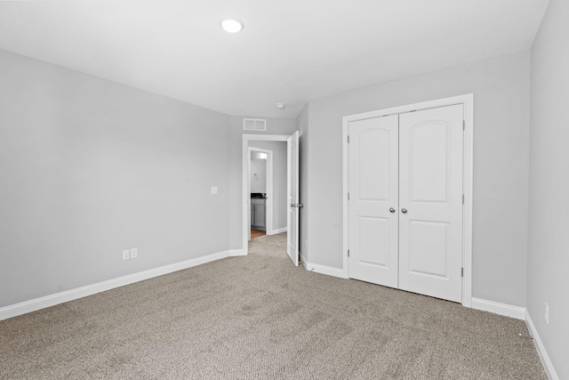 unfurnished bedroom featuring visible vents, carpet, and baseboards