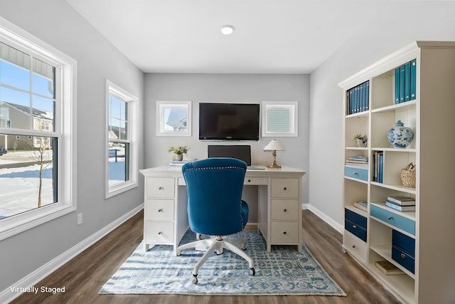 office with dark wood-type flooring and baseboards