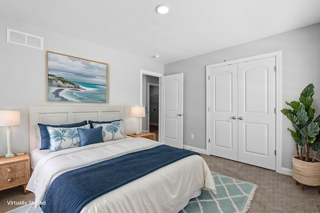 bedroom featuring a closet, visible vents, carpet floors, and baseboards