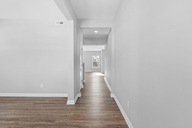 doorway to outside with dark wood-style floors and baseboards