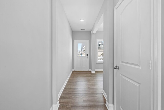 empty room with dark wood finished floors and baseboards