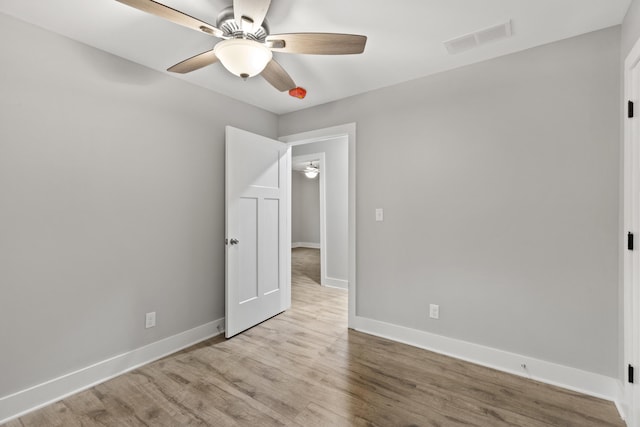 unfurnished room with ceiling fan and light wood-type flooring