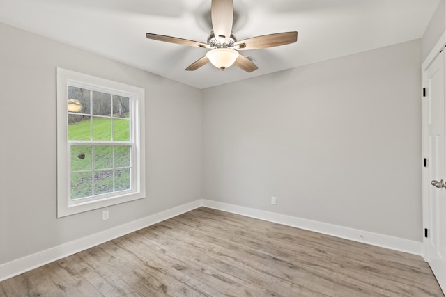 empty room featuring ceiling fan and light hardwood / wood-style flooring