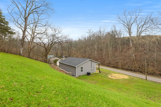 view of side of home with a lawn