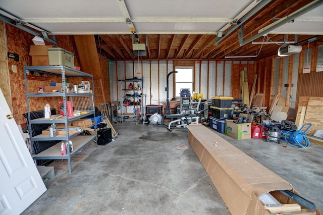 garage with a workshop area and a garage door opener