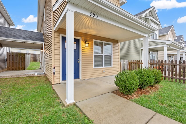 entrance to property with a lawn and a porch