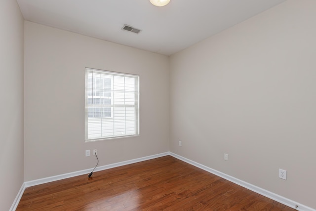 unfurnished room with hardwood / wood-style floors