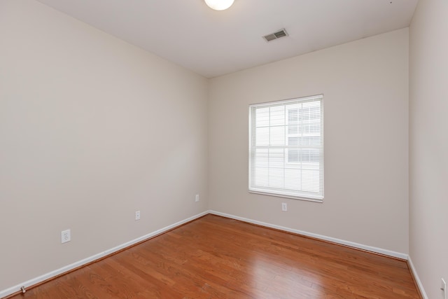 spare room with hardwood / wood-style flooring