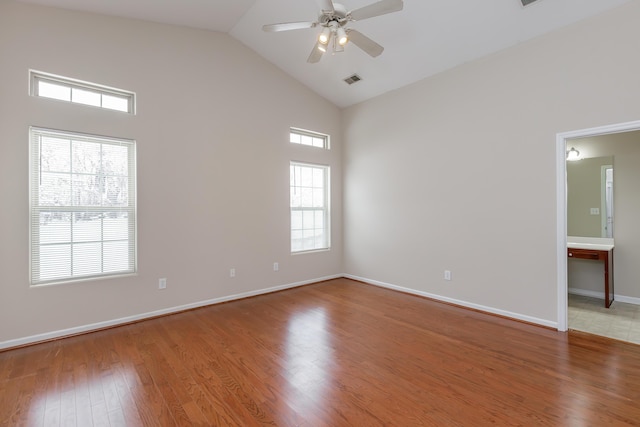 empty room featuring ceiling fan, wood-type flooring, and high vaulted ceiling