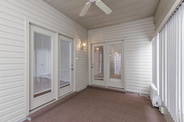 unfurnished sunroom with ceiling fan