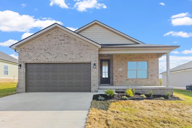 view of front of home featuring central AC unit, a front yard, and a garage