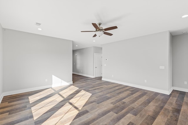 empty room with ceiling fan and dark hardwood / wood-style flooring