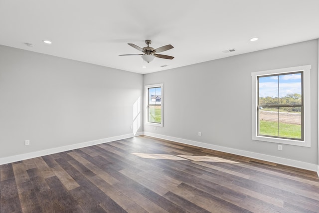 spare room featuring ceiling fan and dark hardwood / wood-style floors