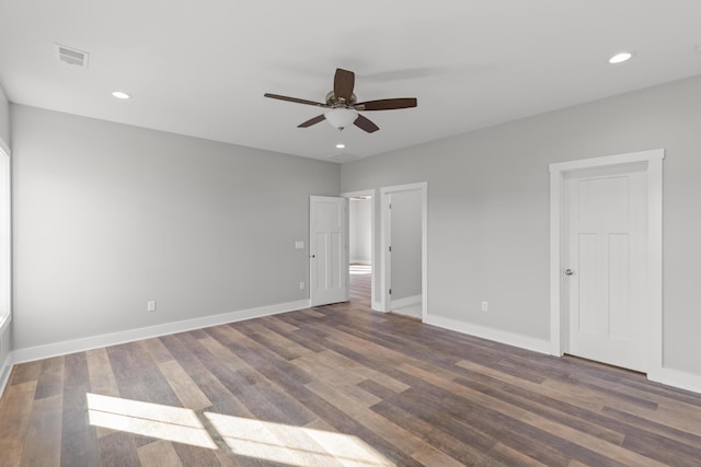 unfurnished bedroom with ceiling fan and dark wood-type flooring