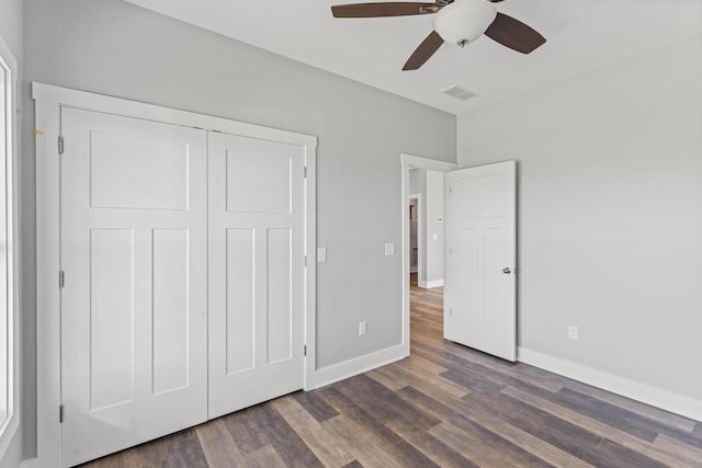 unfurnished bedroom featuring a closet, ceiling fan, and dark hardwood / wood-style floors