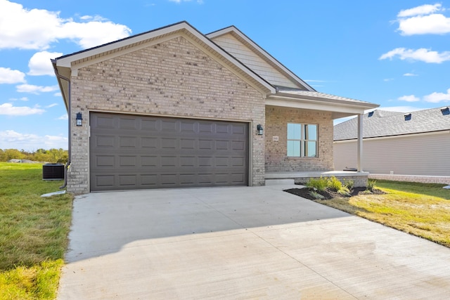 view of front facade featuring a garage, a front yard, and central AC