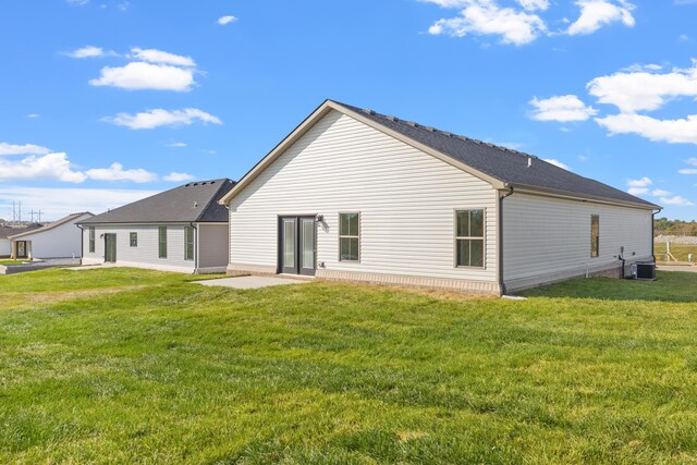 back of house featuring a lawn, central AC, and a patio