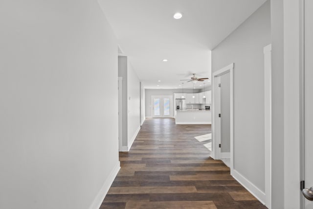 corridor with dark hardwood / wood-style flooring