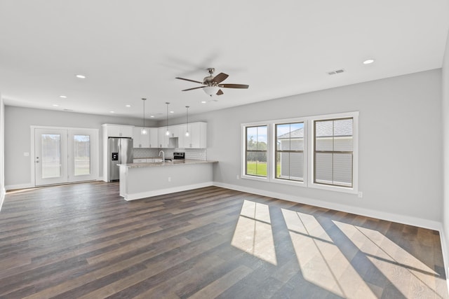 unfurnished living room with ceiling fan, dark wood-type flooring, and sink