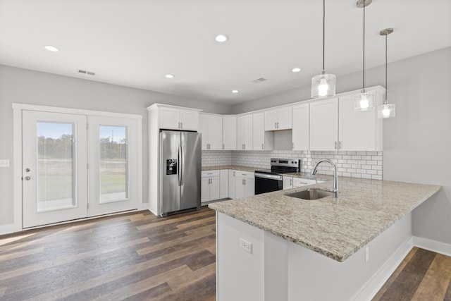 kitchen with sink, dark hardwood / wood-style floors, decorative light fixtures, white cabinetry, and stainless steel appliances