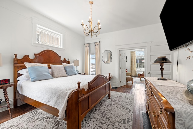 bedroom featuring hardwood / wood-style flooring and a notable chandelier