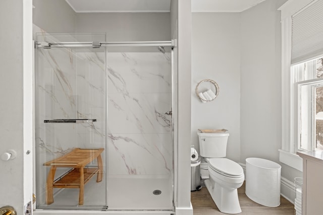 bathroom featuring hardwood / wood-style floors, a healthy amount of sunlight, and walk in shower