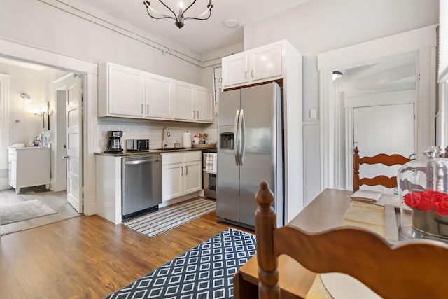 424 S 4th St, Danville, KY 40422 - kitchen featuring appliances with stainless steel finishes, a sink, light wood-type flooring, and white cabinetry