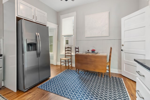 424 S 4th St, Danville, KY 40422 - kitchen with stainless steel refrigerator with ice dispenser, light wood-style flooring, white cabinets, and a wainscoted wall