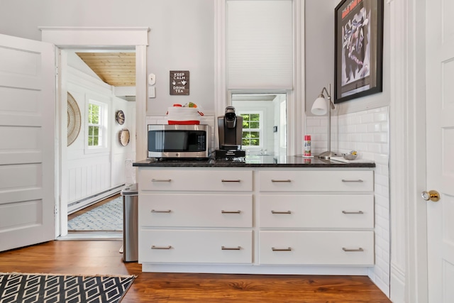 424 S 4th St, Danville, KY 40422 - kitchen featuring stainless steel microwave, baseboard heating, dark wood-type flooring, white cabinets, and vaulted ceiling