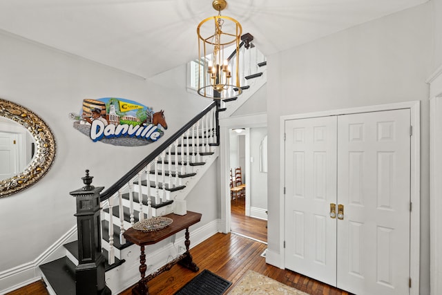 foyer with dark hardwood / wood-style floors and an inviting chandelier