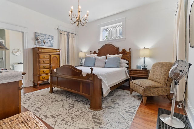 424 S 4th St, Danville, KY 40422 - bedroom with wood-type flooring and a chandelier
