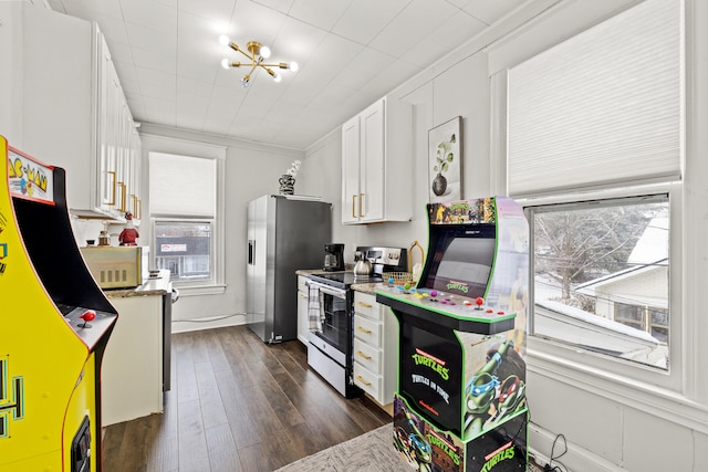 kitchen featuring light stone countertops, dark wood-type flooring, appliances with stainless steel finishes, white cabinets, and ornamental molding